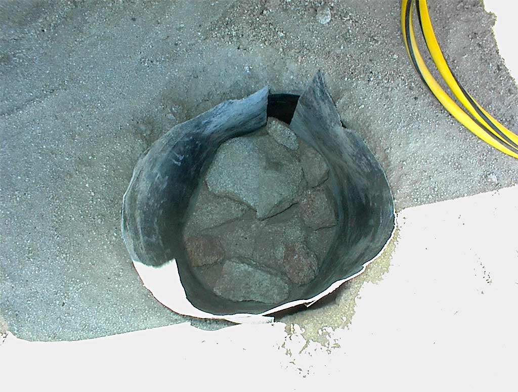 Post on aluminum foot around PVC pipe embedded in concrete footing