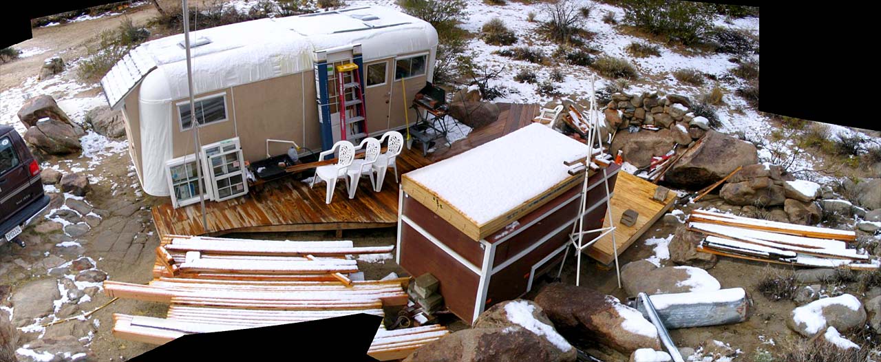 A full site panoramic: the van, trailers, deck and shed-to-be