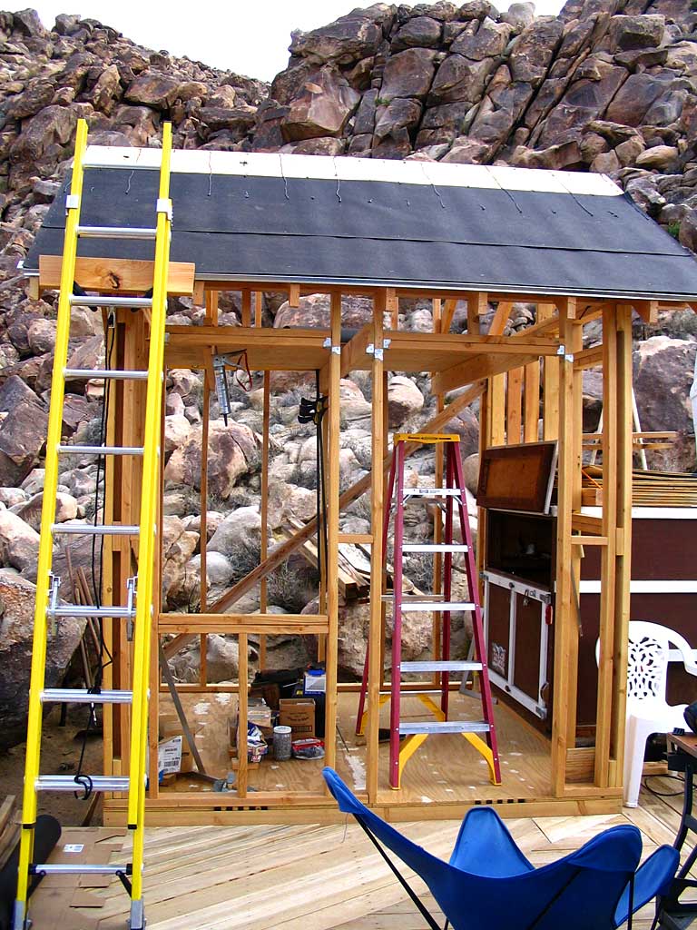 Cementing and stapling roofing paper over the plywood