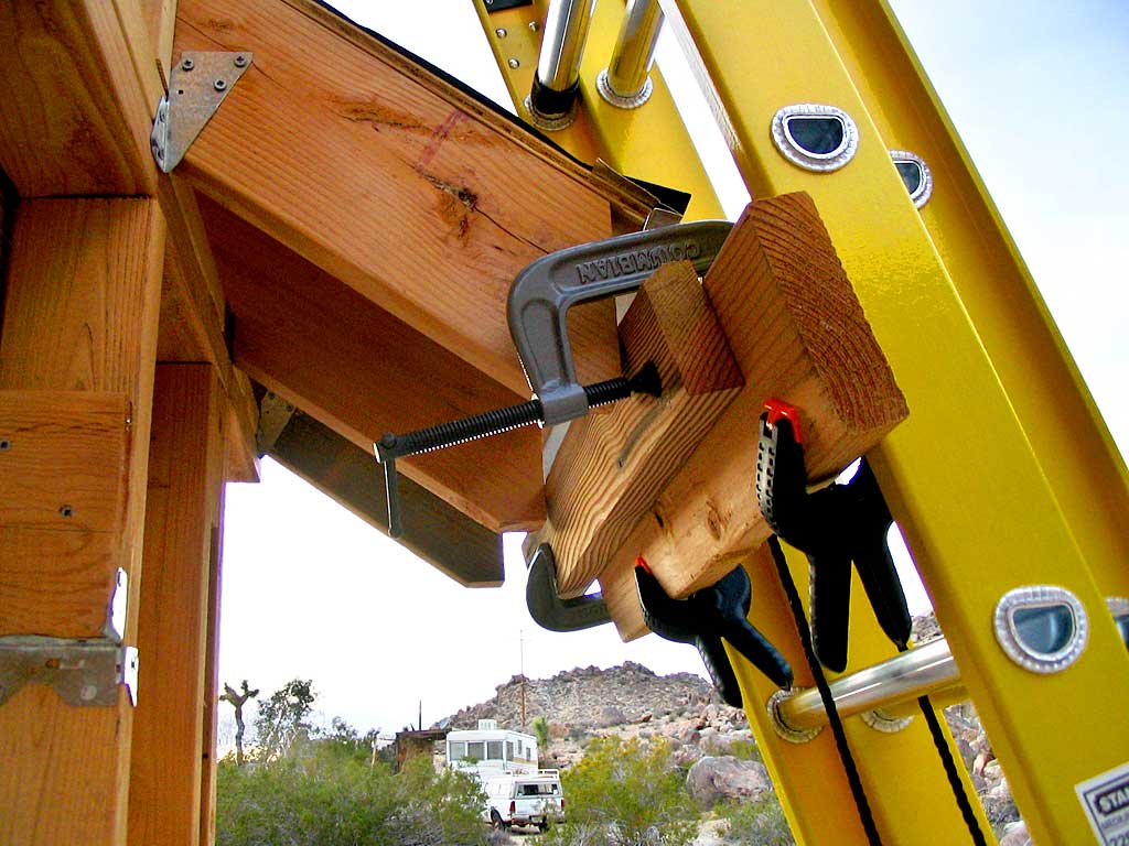 Pushing the ladder away from the roof's edge