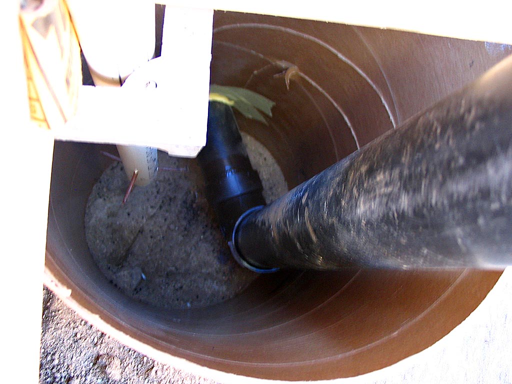 The PVC drain pipe will pass down through the concrete and out to its field