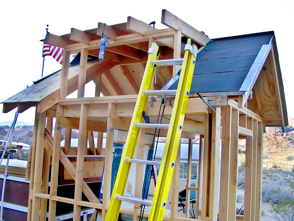 Roofing paper and drip edging are cemented and stapled/nailed to the 1/2 plywood sheething