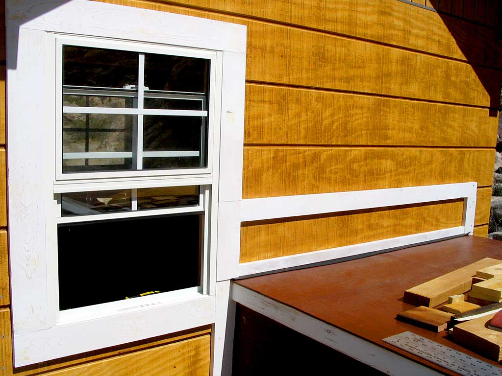 The gate above the trailer is screwed only to the shed