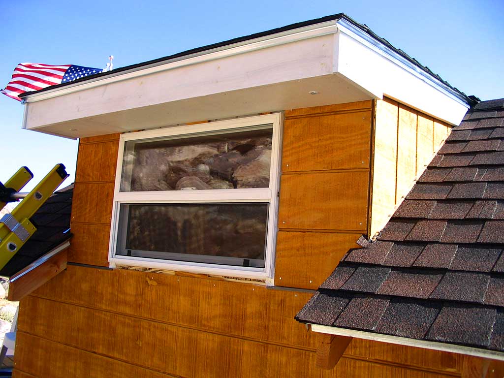 The dormer's soffit and rake boards are installed