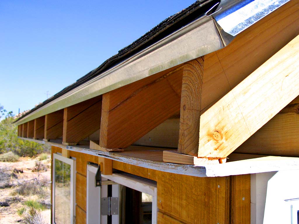 Attached front soffit base with glued shims to compensate for warped rafters