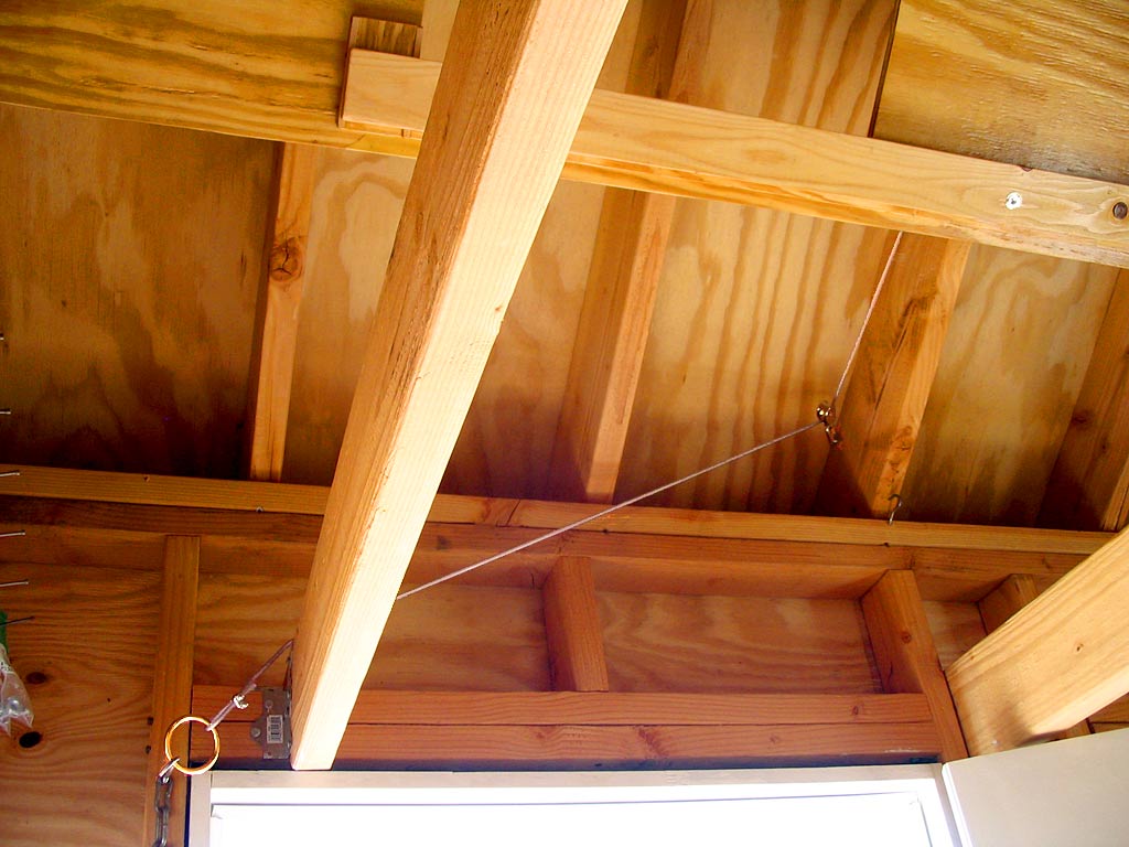 This cable, pully and brass ring system pulls the wall up out of the way