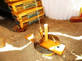 forming a post Hole for the south center of the shed platform