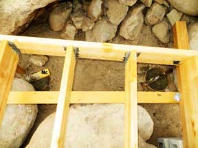 forming post Holes for the north center and NE corner of the shed platform