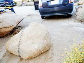 A Toyota Prius is able to drag a small boulder with ease