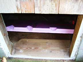 The inside backboard of the cottage crawlspace insulating block