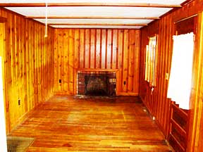 Livingroom, outside door and propane floor furnace