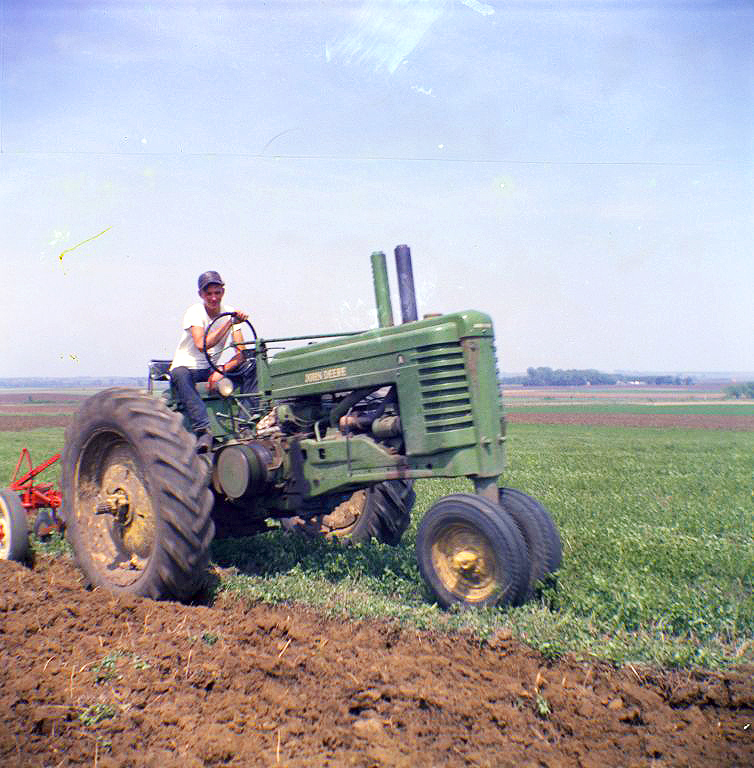 Plowing with a John Deere tractor. Van