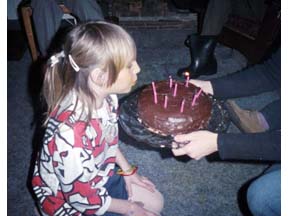 Darby Blakeman blowing out candles on her birthday cake. Mashnee Island, MA. February 07, 1987
